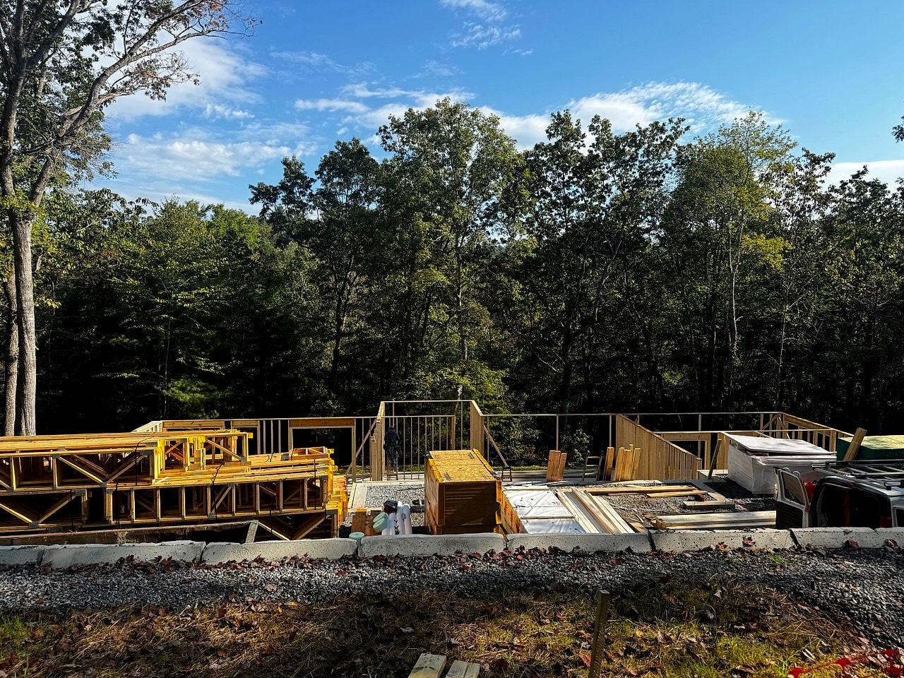 First-floor deck framed over the foundation with the forest beyond