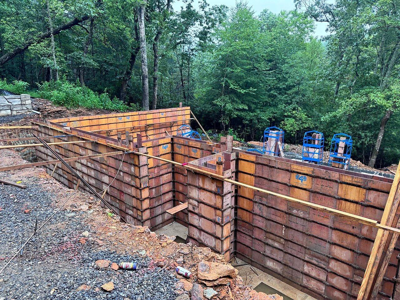 Aluminium wall forms set on the footings in the woods