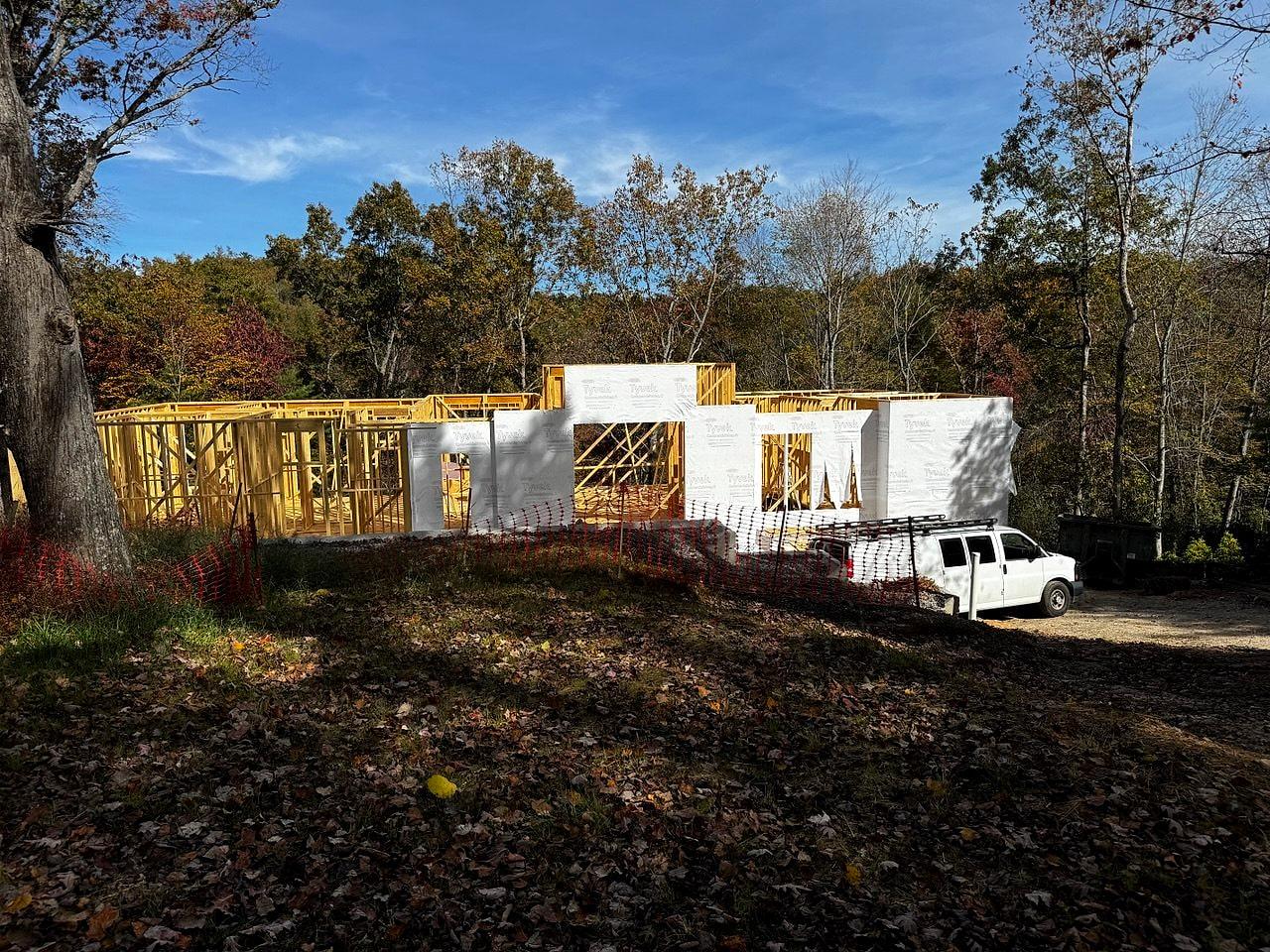 The shell framed on its wooded lot in autumn light