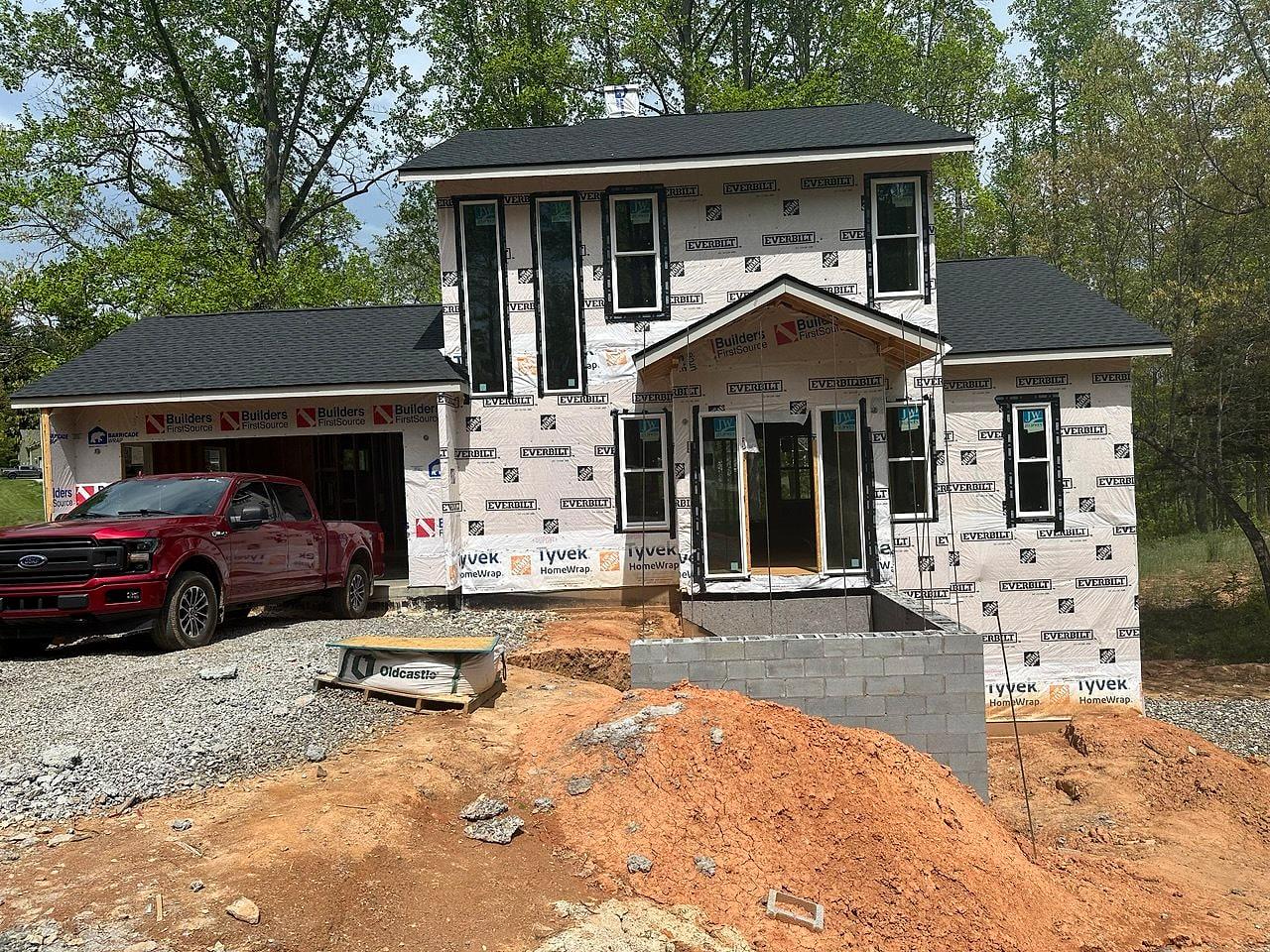 Two-story new build dried in and wrapped, block foundation walls going up
