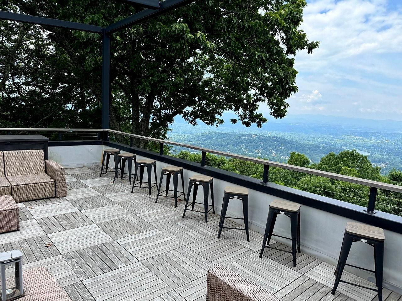 Rooftop deck with a bar rail looking out over the Asheville valley and the Blue Ridge